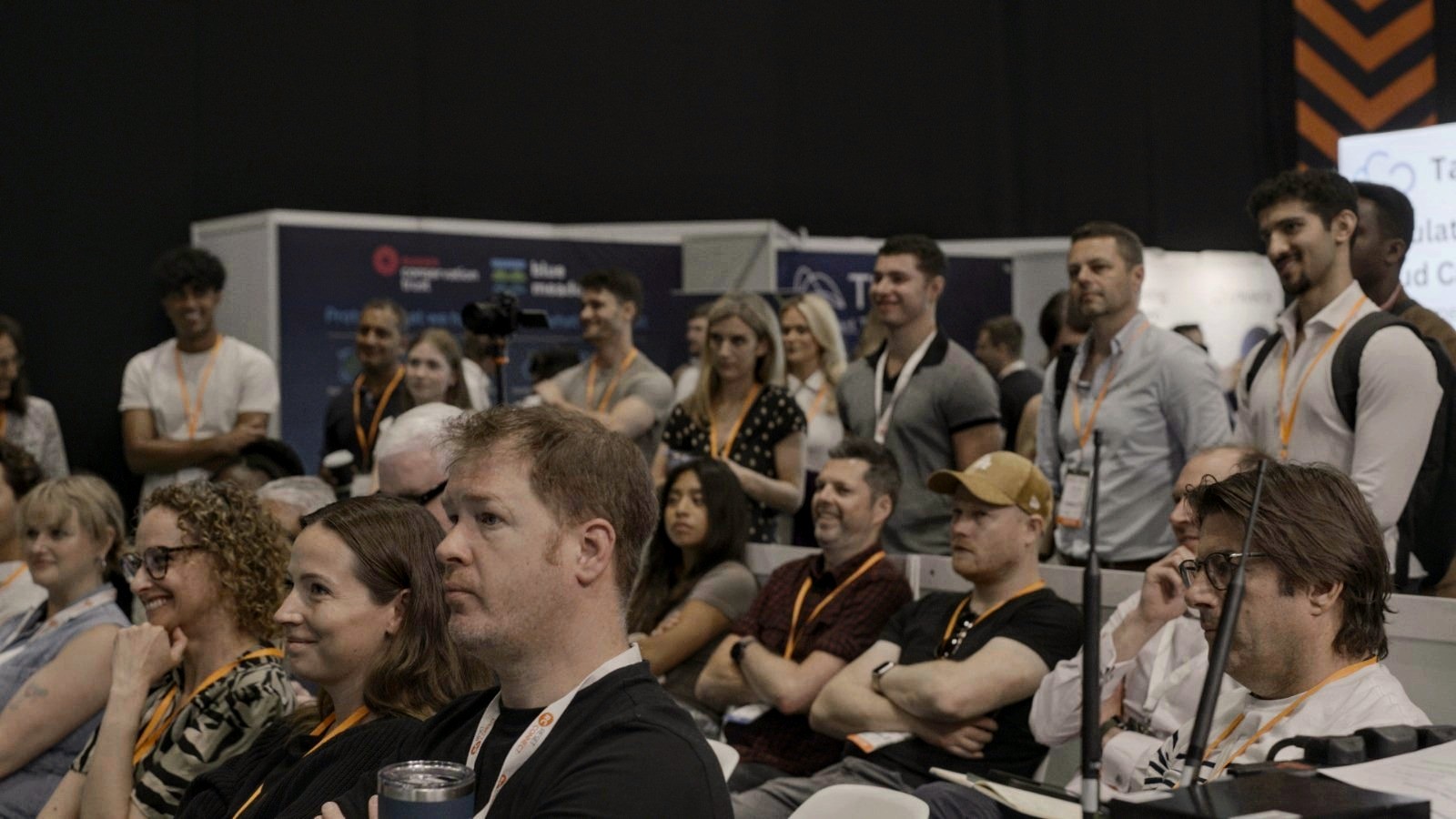 Seated and standing audience watching the Reset Connect talk