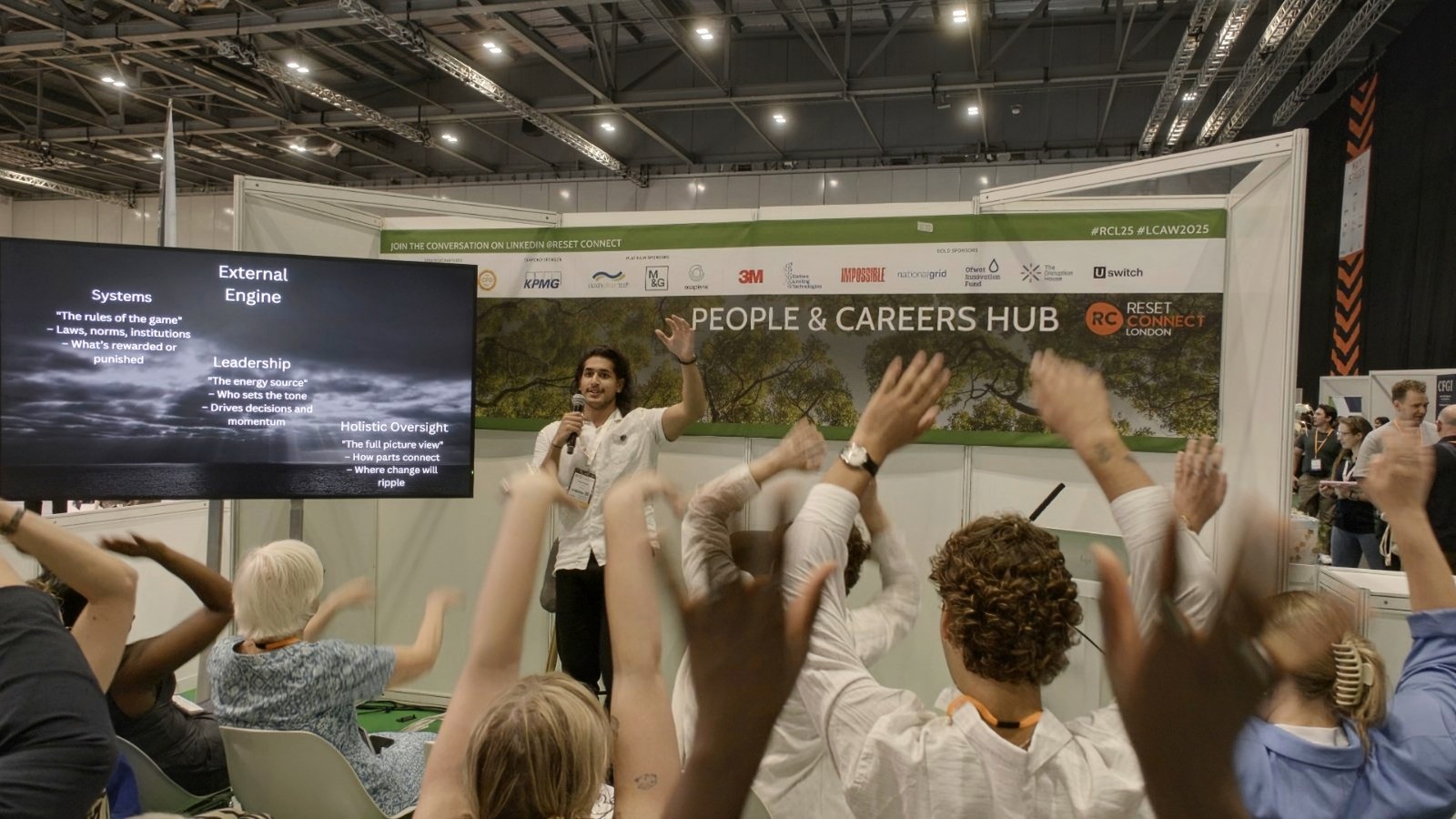 Aadam and the Reset Connect audience raising their hands together
